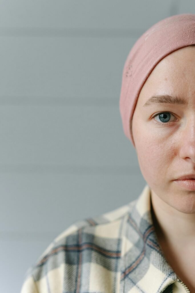 Half-face portrait of a woman wearing a headscarf, symbolizing strength and recovery.